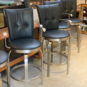 Tuscany leather and brushed steel swivel counter stools with arms