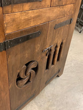 Rustic wood cabinet with metal hinges and pulls