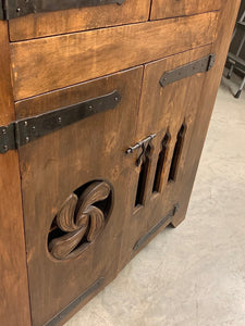 Rustic wood cabinet with metal hinges and pulls