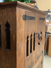 Rustic wood cabinet with metal hinges and pulls