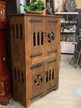 Rustic wood cabinet with metal hinges and pulls
